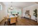 Spacious dining room boasts hardwood floors and a modern chandelier, flowing into the living room at 151 Monteith Dr, Chapel Hill, NC 27516