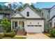 Charming home with white siding, well-manicured lawn, and a welcoming two-car garage at 151 Monteith Dr, Chapel Hill, NC 27516