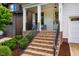 Cozy brick front porch with seating and charming details, perfect for relaxing outdoors at 151 Monteith Dr, Chapel Hill, NC 27516