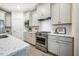 Bright kitchen features stainless appliances, white cabinets and countertops, and subway tile backsplash at 151 Monteith Dr, Chapel Hill, NC 27516