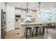 Modern kitchen with a large island, pendant lighting, stainless steel appliances, and open dining area at 151 Monteith Dr, Chapel Hill, NC 27516
