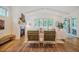 Bright living room boasts a fireplace, vaulted ceilings, and multiple windows with wooded views at 151 Monteith Dr, Chapel Hill, NC 27516