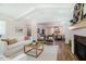 Airy living room boasts a modern fireplace, sleek furniture and seamless flow to the dining area at 151 Monteith Dr, Chapel Hill, NC 27516