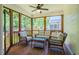 Relaxing screened porch with wicker furniture, ceiling fan and view of the backyard at 151 Monteith Dr, Chapel Hill, NC 27516