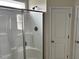 Bathroom featuring a glass enclosed shower and a white storage closet at 152 Springtooth Dr, Zebulon, NC 27597