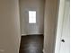 View of hallway features hardwood floors, neutral walls, and white trim at 152 Springtooth Dr, Zebulon, NC 27597