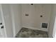 Laundry room with modern, geometric floor tiles and utility connections at 152 Springtooth Dr, Zebulon, NC 27597