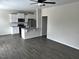 View of open concept living and kitchen area with hardwood floors and neutral paint at 152 Springtooth Dr, Zebulon, NC 27597