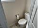Close up of a white toilet with a marble tiled floor at 152 Springtooth Dr, Zebulon, NC 27597