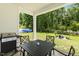 Enjoyable outdoor patio with grill, dining set and view of a well-kept backyard at 159 Mitchell Manor Dr, Angier, NC 27501