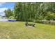 Well-manicured backyard with fire pit and outdoor seating offers a great entertaining space at 159 Mitchell Manor Dr, Angier, NC 27501