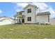 Spacious backyard featuring a charming two-story home, covered patio, and white picket fence for privacy at 159 Mitchell Manor Dr, Angier, NC 27501
