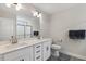 Bathroom featuring double sinks, a large mirror, a glass-enclosed shower, and gray flooring at 159 Mitchell Manor Dr, Angier, NC 27501