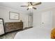 Bright bedroom with gray wood-look floors, ceiling fan, and a wood dresser at 159 Mitchell Manor Dr, Angier, NC 27501
