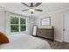 Bright bedroom with gray wood-look floors, ceiling fan, and a large window at 159 Mitchell Manor Dr, Angier, NC 27501