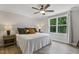 Bright bedroom features a ceiling fan, a large window with natural light, and neutral walls at 159 Mitchell Manor Dr, Angier, NC 27501