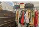 Walk-in closet with hanging racks, stacked luggage, and a dark dresser with gold pulls at 159 Mitchell Manor Dr, Angier, NC 27501