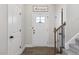 Bright foyer with wood floors, white trim, and a staircase, creating a welcoming entrance at 159 Mitchell Manor Dr, Angier, NC 27501