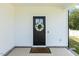 Inviting front door with a decorative wreath, set against a clean, modern facade and a welcoming welcome mat at 159 Mitchell Manor Dr, Angier, NC 27501