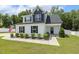 Inviting two-story home with white siding, black accents, and a neatly landscaped front yard under a clear blue sky at 159 Mitchell Manor Dr, Angier, NC 27501