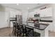 Modern kitchen island with sleek black countertops and seating, perfect for casual dining at 159 Mitchell Manor Dr, Angier, NC 27501