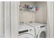 Well-organized laundry room features modern washer, dryer, and shelving for storage at 159 Mitchell Manor Dr, Angier, NC 27501