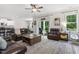 Open concept living room flowing into the kitchen, featuring hardwood floors, comfortable sofas, and ample natural light at 159 Mitchell Manor Dr, Angier, NC 27501