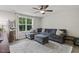 Living room featuring a gray sectional sofa, a window, and a decorative ladder at 159 Mitchell Manor Dr, Angier, NC 27501