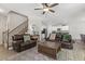 Spacious living room with hardwood floors, comfortable sofas, a ceiling fan, and a view into the kitchen at 159 Mitchell Manor Dr, Angier, NC 27501