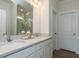 Bright bathroom with double sinks, white cabinets, neutral paint, and modern fixtures at 162 Sugar Pine Drive, Franklinton, NC 27525