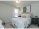 Cozy bedroom with neutral carpet, full bed, and a large window letting in natural light at 162 Sugar Pine Drive, Franklinton, NC 27525