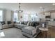 Open-concept living area with an over sized sectional sofa and open to the kitchen at 162 Sugar Pine Drive, Franklinton, NC 27525