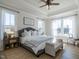 Bright main bedroom with tray ceiling, ceiling fan, multiple windows, and neutral decor at 162 Sugar Pine Drive, Franklinton, NC 27525