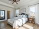 Beautiful bedroom features tray ceiling, many windows, and a gray upholstered bed with white linens at 162 Sugar Pine Drive, Franklinton, NC 27525