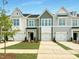 Attractive new construction townhomes featuring colorful siding, large garages and neatly manicured lawns at 166 Ripple Way # 323, Clayton, NC 27520