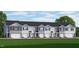 A row of townhomes with gray siding, white trim, and a well-maintained front lawn at 169 Holton St, Smithfield, NC 27577