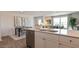 Bright open kitchen featuring white cabinets, stainless steel appliances, and an island with a sink at 169 Holton St, Smithfield, NC 27577