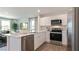 Open kitchen with stainless steel appliances, white cabinetry, and an island with a sink at 177 Holton St, Smithfield, NC 27577