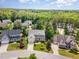 Aerial view of a lovely home surrounded by mature trees and well-maintained lawns in a quiet neighborhood at 1952 Combine Cir, Apex, NC 27502