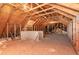 Spacious unfinished attic with exposed beams and insulation, offering possibilities for conversion at 1952 Combine Cir, Apex, NC 27502