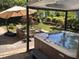 Beautiful backyard with a hot tub, patio, umbrella, and seating area perfect for relaxation at 1952 Combine Cir, Apex, NC 27502