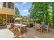 Outdoor kitchen and dining area with a grill, bar seating, and a covered hot tub at 1952 Combine Cir, Apex, NC 27502