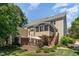 Spacious backyard featuring a screened porch, deck stairs, hot tub, and outdoor dining area at 1952 Combine Cir, Apex, NC 27502
