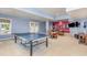 Large finished basement with ping pong table, ample lighting, and adjacent living area for Gathering gatherings at 1952 Combine Cir, Apex, NC 27502