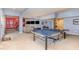 Spacious finished basement featuring a ping pong table and living area, perfect for recreation and relaxation at 1952 Combine Cir, Apex, NC 27502