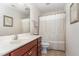 A well-maintained bathroom featuring a single sink vanity, a toilet, and a shower with a patterned curtain at 1952 Combine Cir, Apex, NC 27502