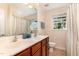 Bathroom features a double sink vanity, a window for natural light, and a shower with a patterned curtain at 1952 Combine Cir, Apex, NC 27502