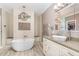 Luxurious bathroom featuring a soaking tub, walk-in shower, heated towel rack, and a vanity with granite countertop at 1952 Combine Cir, Apex, NC 27502
