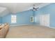 Spacious bedroom features two windows, a ceiling fan, and vaulted ceilings, providing ample natural light and air circulation at 1952 Combine Cir, Apex, NC 27502