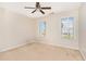 Bright and airy bedroom with two windows offering natural light and a ceiling fan for added comfort at 1952 Combine Cir, Apex, NC 27502